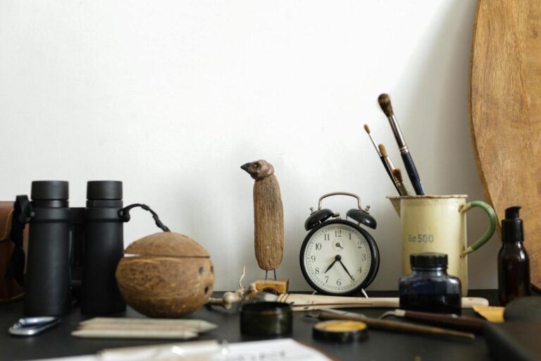 A creative arrangement of art supplies and objects on a desk with a vintage vibe.
